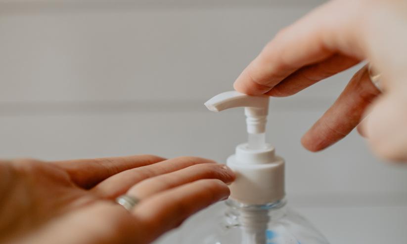 two hands using hand sanitiser