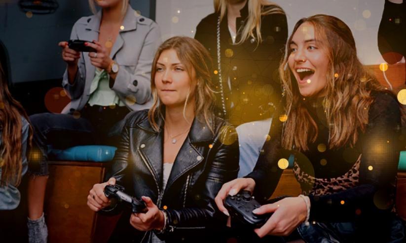 A group of people smiling and laughing playing video games at E-sports at Platform (Shoreditch)