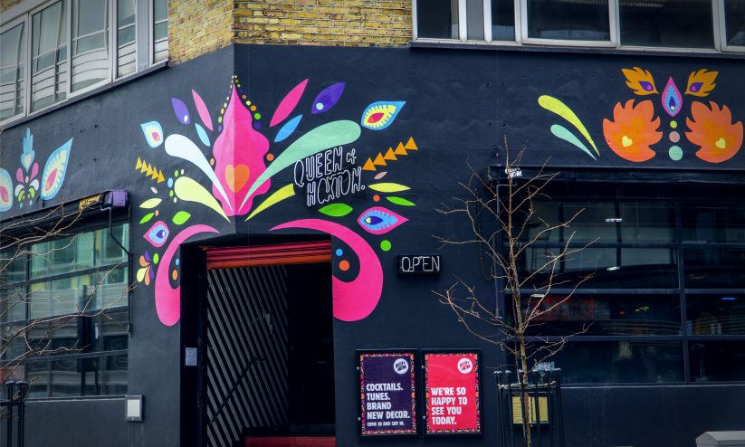 Brightly coloured frontage of The Queen of Hoxton, a roof-top bar in Shoreditch