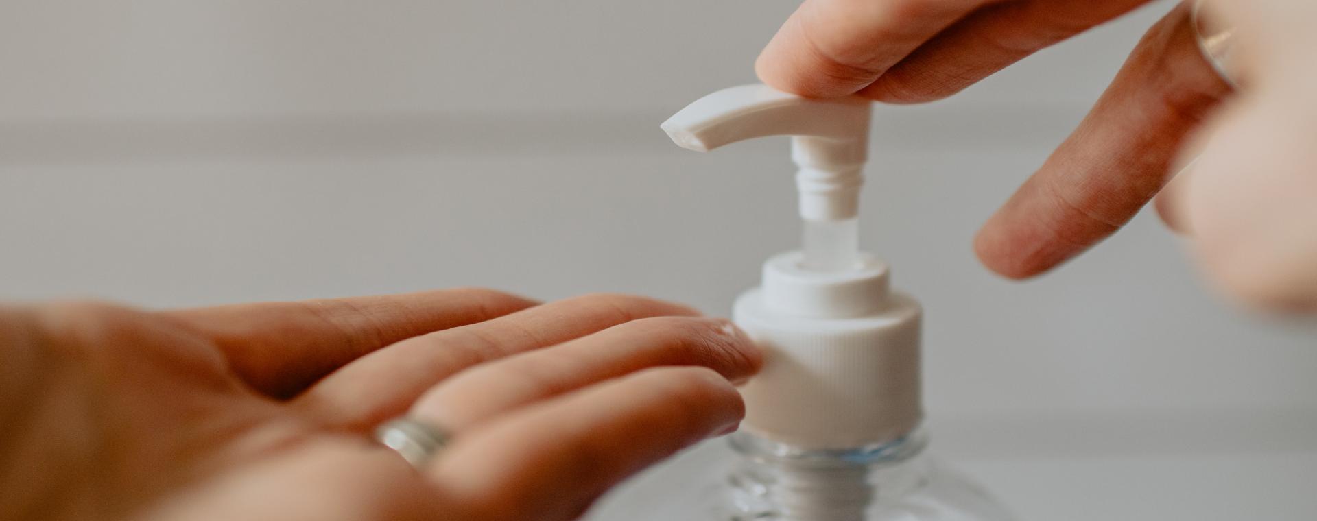 two hands using hand sanitiser