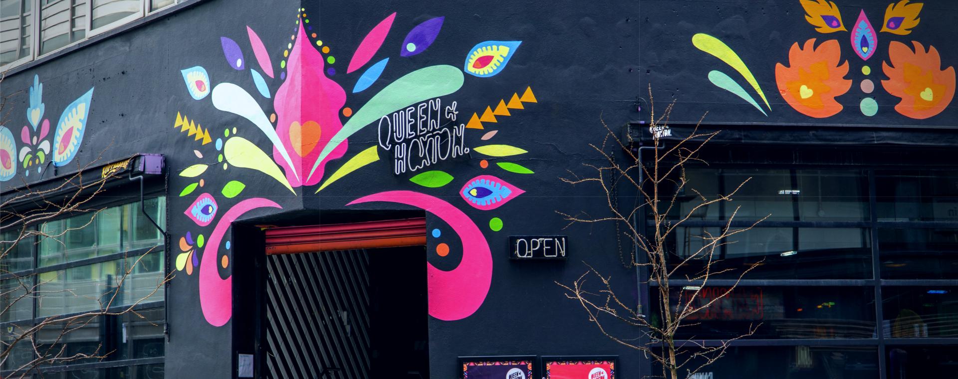 Brightly coloured frontage of The Queen of Hoxton, a roof-top bar in Shoreditch