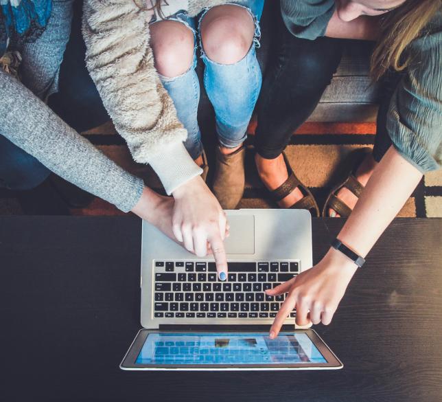 people around a laptop