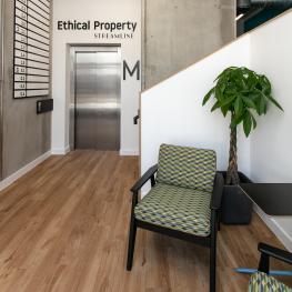 Chair, pot plant and lift in foyer area of Streamline