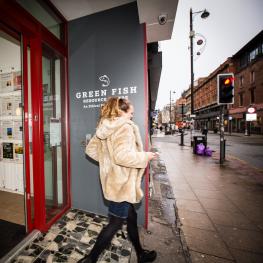 Tenant walking out of the front of Green Fish